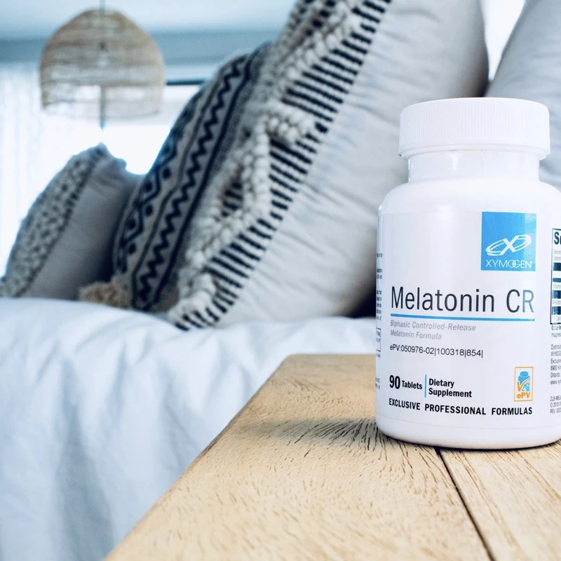 Bottle of XYMOGEN Melatonin CR on table