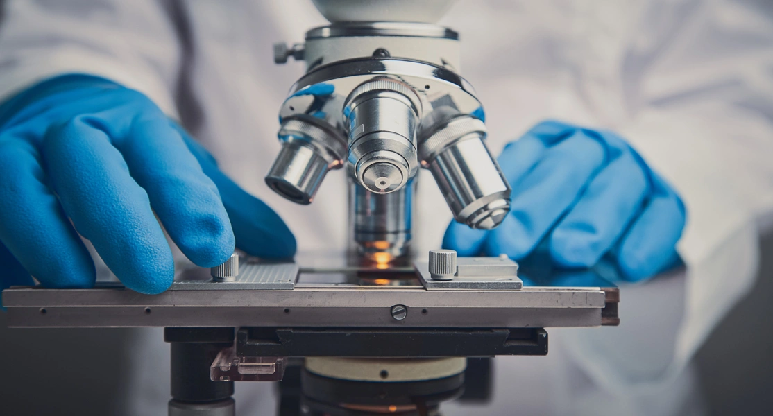 Man working at a microscope